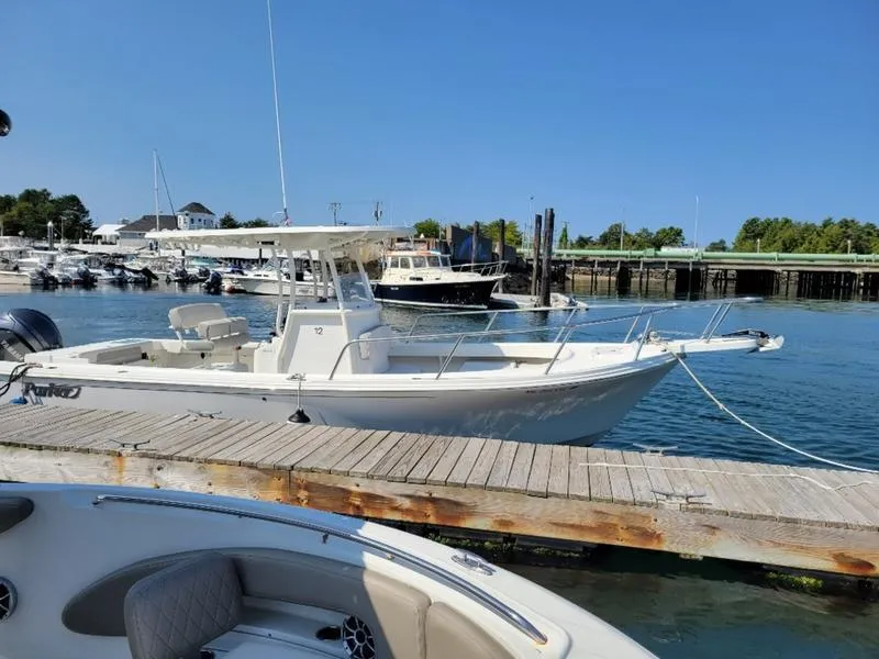 Slide: The Image of 2023 Parker 2500 SE boat docked at marina under clear blue sky. - 10