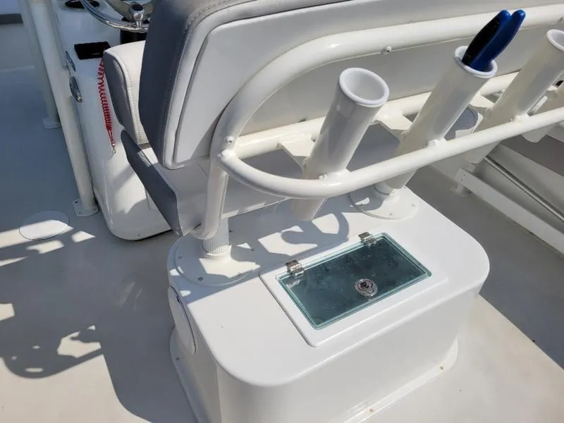Slide: The Image of 2023 Parker 2500 SE boat interior with rod holders and storage compartment. - 11