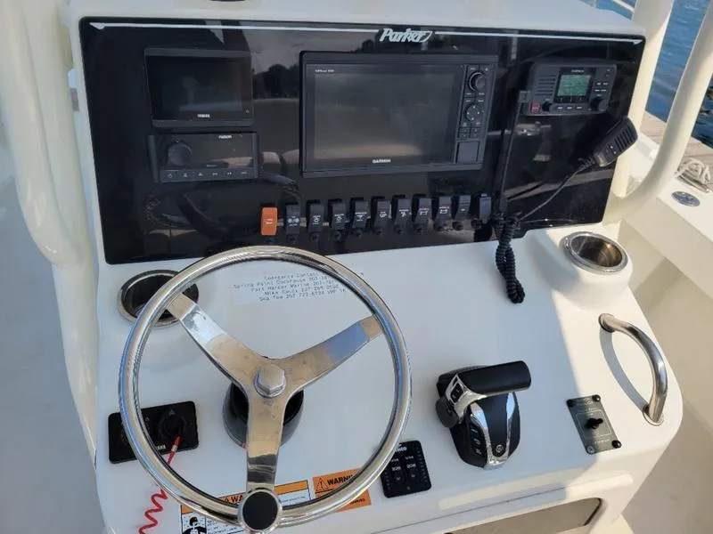 Slide: The Image of 2023 Parker 2500 SE boat dashboard with steering wheel and control panel. - 12