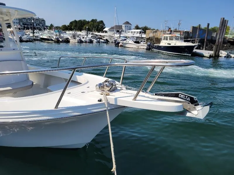 Slide: The Image of 2023 Parker 2500 SE boat docked in a marina with clear blue water. - 15