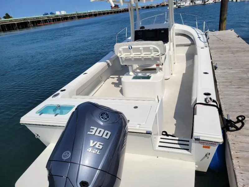 Slide: The Image of 2023 Parker 2500 SE boat with Yamaha 300 V6 engine docked by the water. - 3