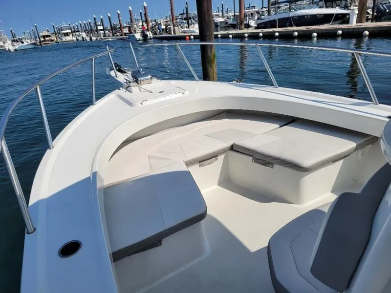 Slide: The Image of 2023 Parker 2500 SE boat with spacious seating at marina. - 5