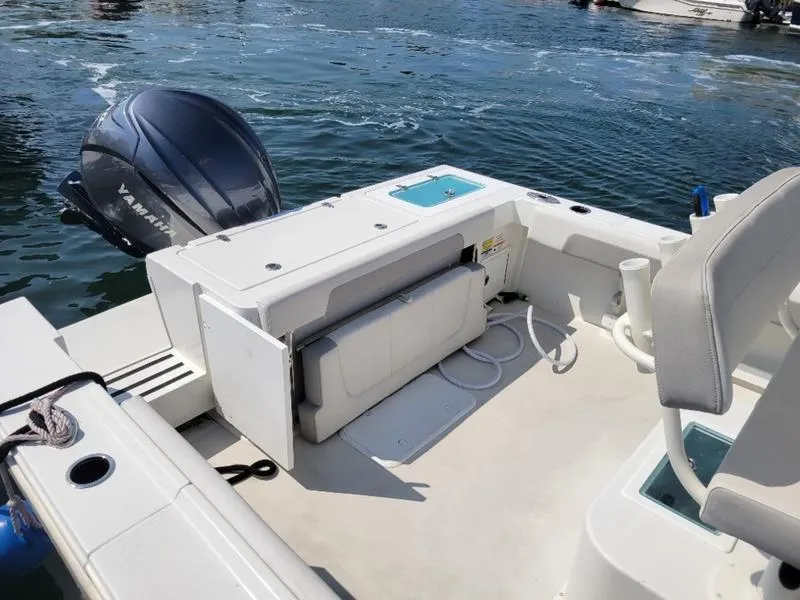 Slide: The Image of 2023 Parker 2500 SE boat with Yamaha outboard engine on calm water. - 6