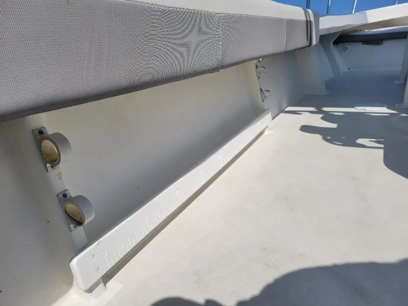 Slide: The Image of 2023 Parker 2500 SE boat interior with cushioned seating and rod holders. - 9