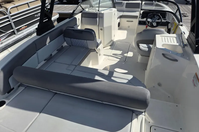 Slide: The Image of 2023 Bayliner DX 2200 boat interior with spacious seating and modern helm. - 5