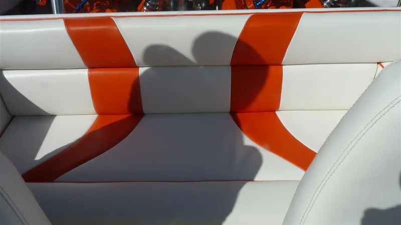 Slide: The Image of 1971 Magnum Sport boat interior with white and orange upholstery. - 11