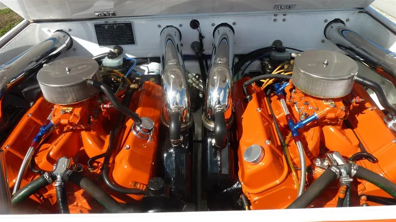 Slide: The Image of 1971 Magnum Sport engine bay with dual orange engines and chrome air filters. - 15