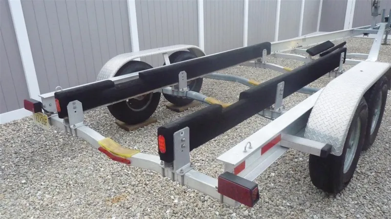Slide: The Image of 1971 Magnum Sport boat trailer with dual axles and padded supports. - 19