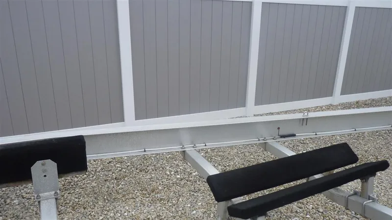 Slide: The Image of Boat trailer for 1971 Magnum Sport on gravel near a white and gray fence. - 23