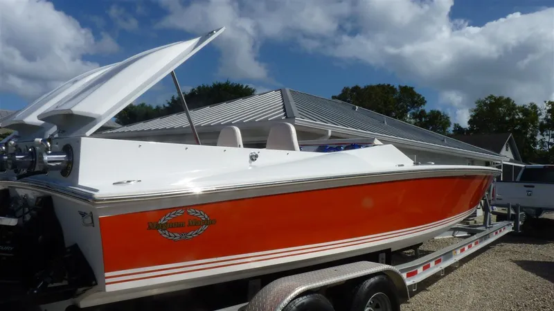 Slide: The Image of 1971 Magnum Sport boat with orange and white exterior on a trailer. - 4
