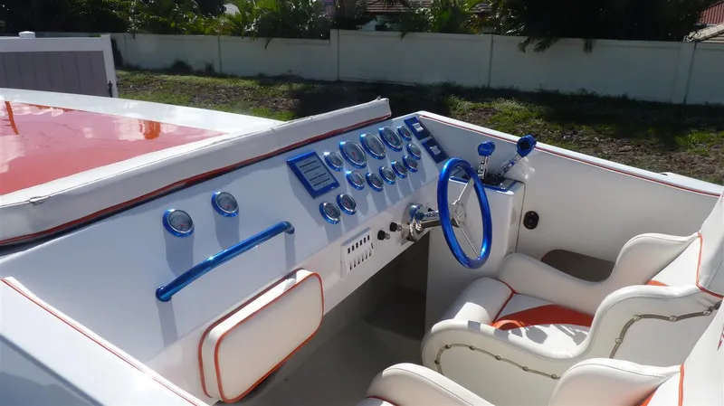 Slide: The Image of 1971 Magnum Sport boat interior with blue and white dashboard and steering wheel. - 6