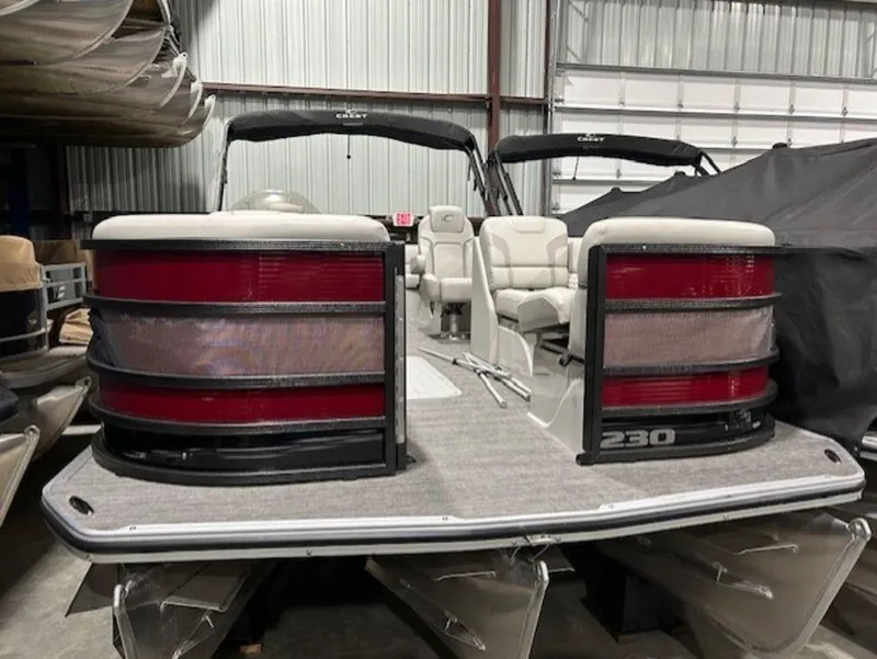 Slide: The Image of 2023 Crest Caribbean LX 230 SLS pontoon boat in a storage facility. - 12