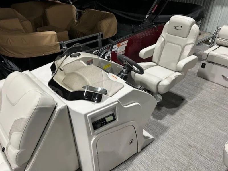Slide: The Image of 2023 Crest Caribbean LX 230 SLS boat interior with captain's chair and control console. - 3