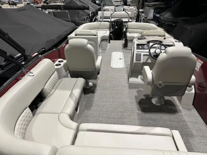 Slide: The Image of 2023 Crest Caribbean LX 230 SLS pontoon boat interior with luxurious seating and modern helm. - 8