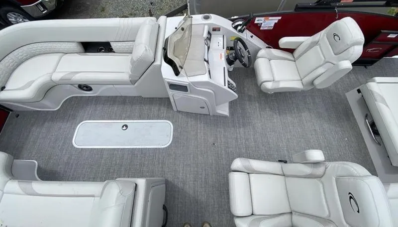 Slide: The Image of 2023 Crest Caribbean LX 230 SLS boat interior with white leather seats and gray flooring. - 9