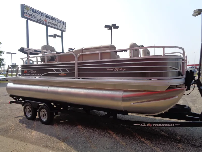 Slide: The Image of 2023 Sun Tracker Fishin' Barge 20 DLX pontoon boat on trailer at Tracker Boating Center. - 3