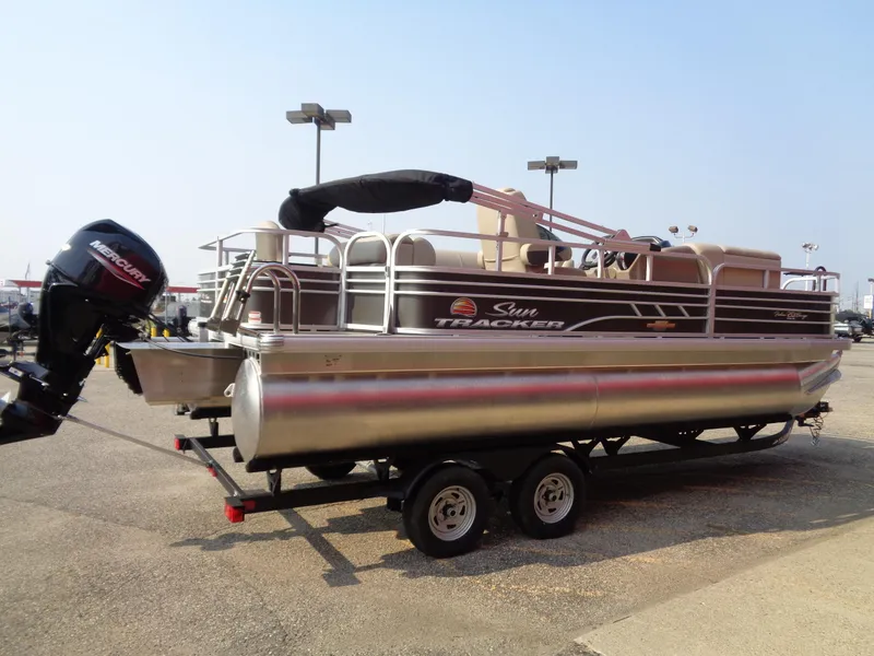Slide: The Image of 2023 Sun Tracker Fishin' Barge 20 DLX pontoon boat on trailer. - 5