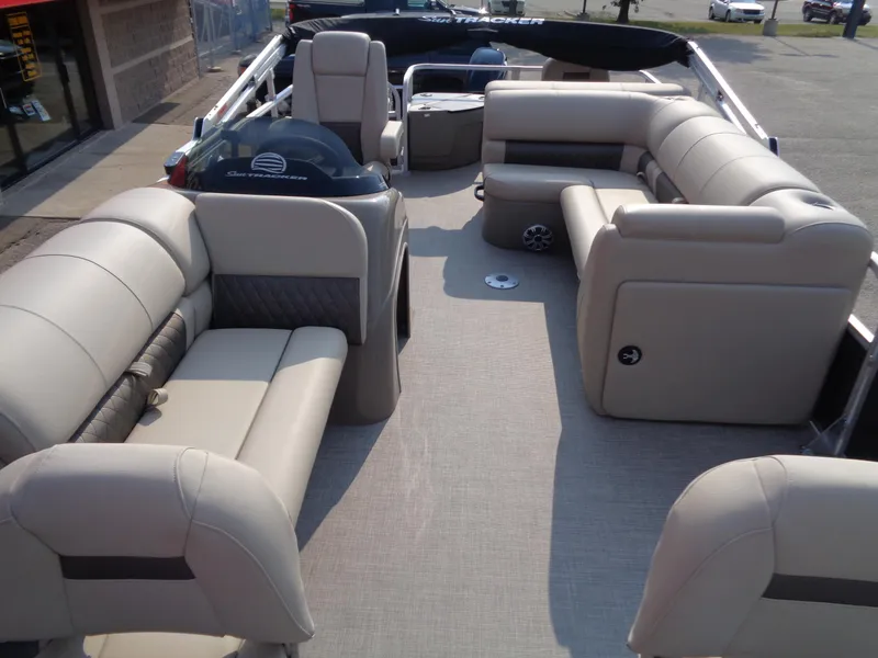 Slide: The Image of 2023 Sun Tracker Fishin' Barge 20 DLX interior with beige seating and spacious layout. - 7