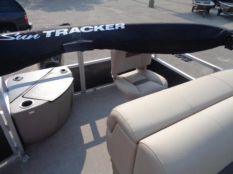 Slide: The Image of 2023 Sun Tracker Fishin' Barge 20 DLX interior with seating and storage. - 8
