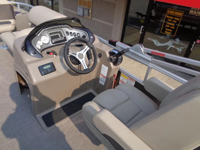 Slide: The Image of 2023 Sun Tracker Fishin' Barge 20 DLX boat helm with steering wheel and controls. - 9
