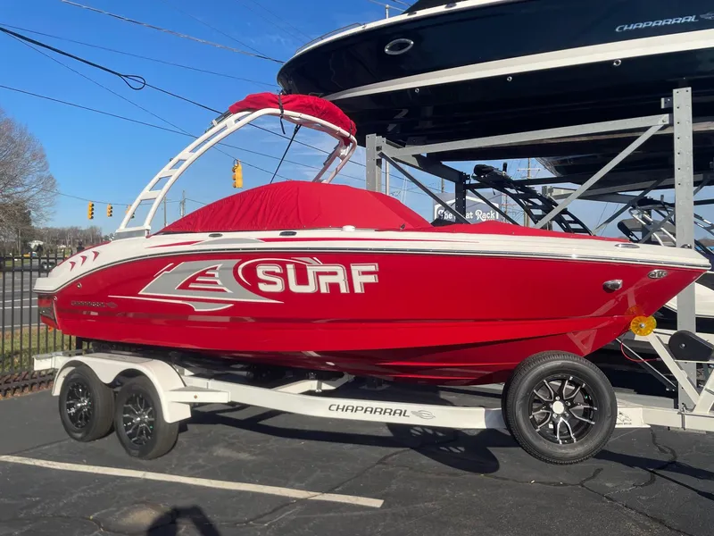 Slide: The Image of 2023 Chaparral 21 Surf boat in red on a trailer. - 0