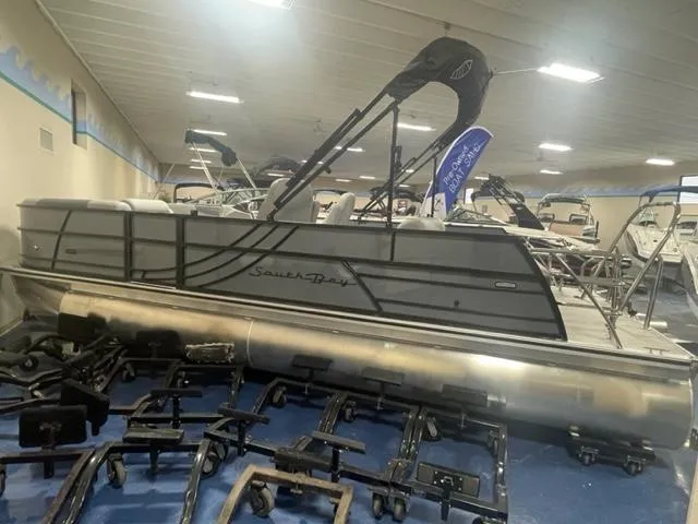 Slide: The Image of 2023 South Bay 224 UL 3.0 pontoon boat displayed indoors. - 1