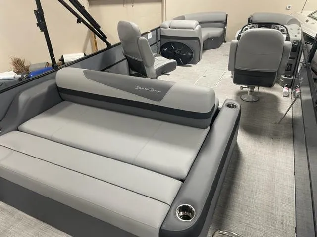 Slide: The Image of 2023 South Bay 224 UL 3.0 pontoon boat interior with gray seating and modern design. - 3