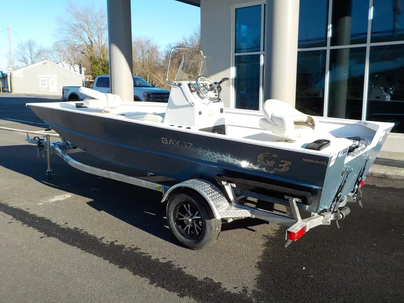 Slide: The Image of 2023 G3 Bay 17 boat on trailer, parked outdoors near a building. - 7
