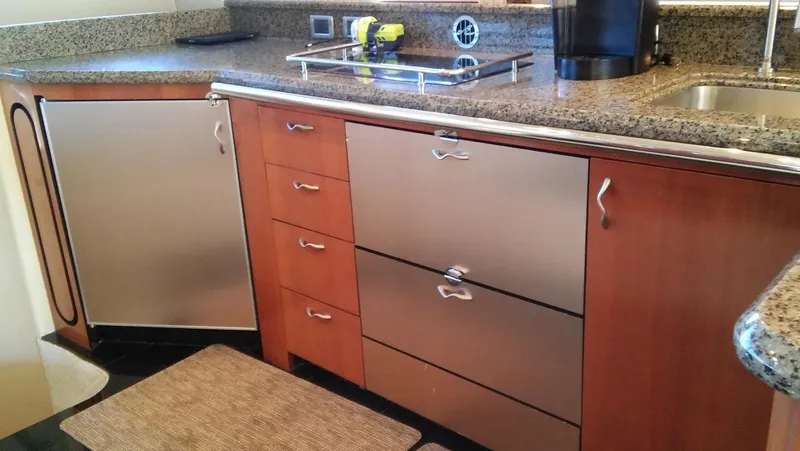Slide: The Image of Modern kitchen area in a 2005 Sea Ray 550 Sedan Bridge yacht. - 13