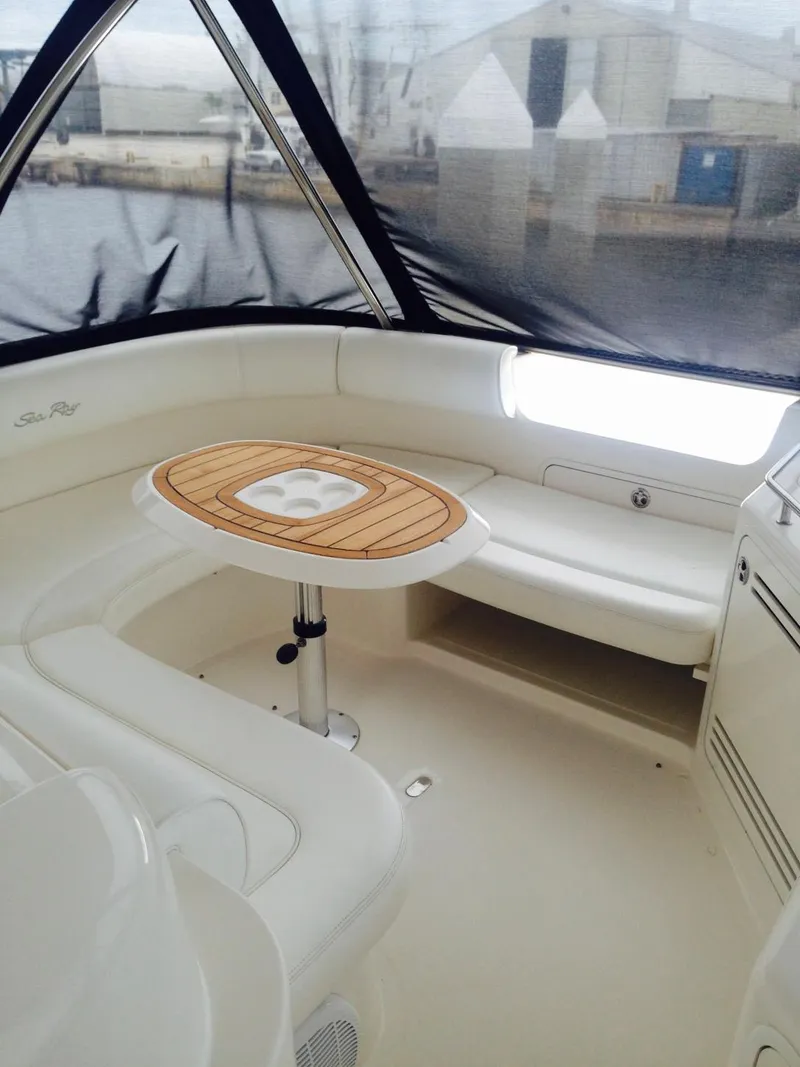 Slide: The Image of 2005 Sea Ray 550 Sedan Bridge interior with seating and table. - 3
