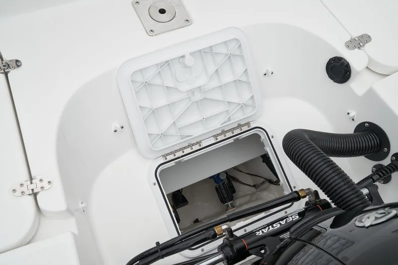 Slide: The Image of Open storage compartment in 2023 Tahoe 1950 boat, showcasing interior and engine components. - 8