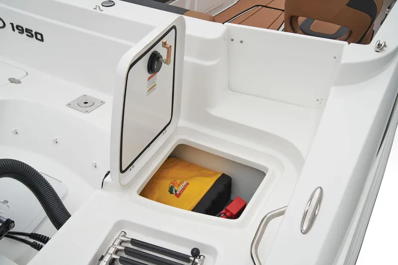 Slide: The Image of Interior view of a 2023 Tahoe 1950 boat storage compartment with safety equipment. - 9