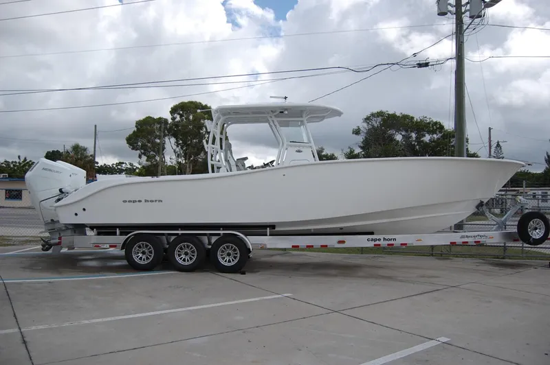 Slide: The Image of 2025 Cape Horn 34Xs boat on a trailer in a parking lot. - 1