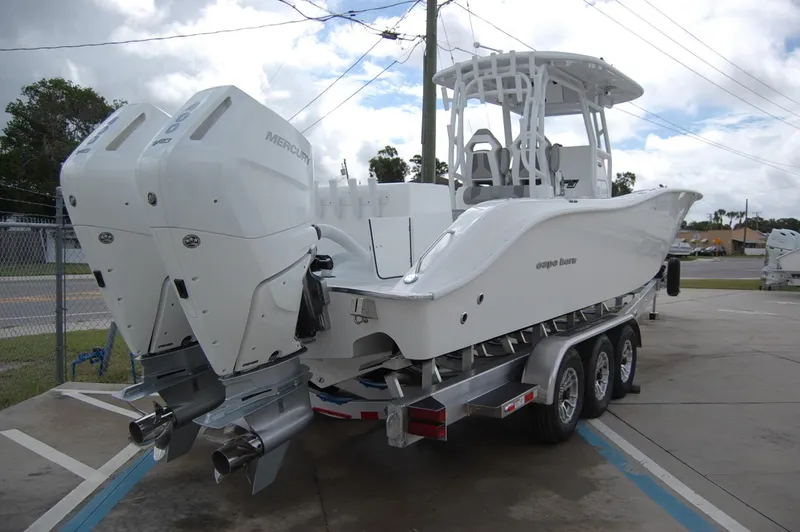 Slide: The Image of 2025 Cape Horn 34Xs boat with twin Mercury engines on a trailer. - 2