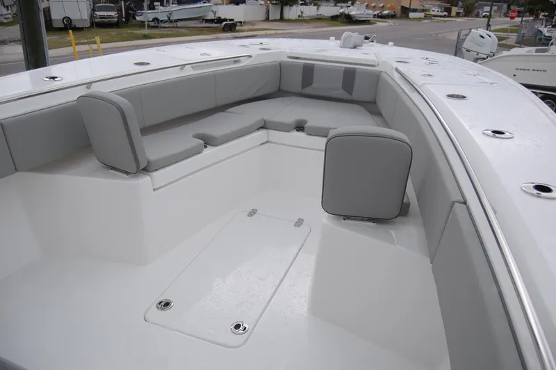 Slide: The Image of 2025 Cape Horn 34Xs boat interior with cushioned seating and storage compartments. - 7