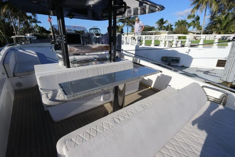 Slide: The Image of 2018 Canados Gladiator 428 yacht interior with white seating and dining area. - 14