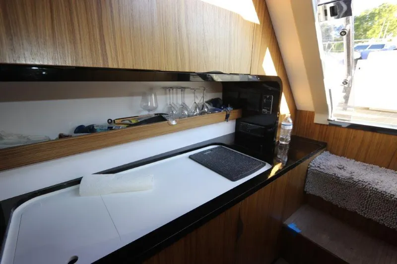 Slide: The Image of Modern kitchen area in 2018 Canados Gladiator 428 yacht with wooden cabinetry. - 6