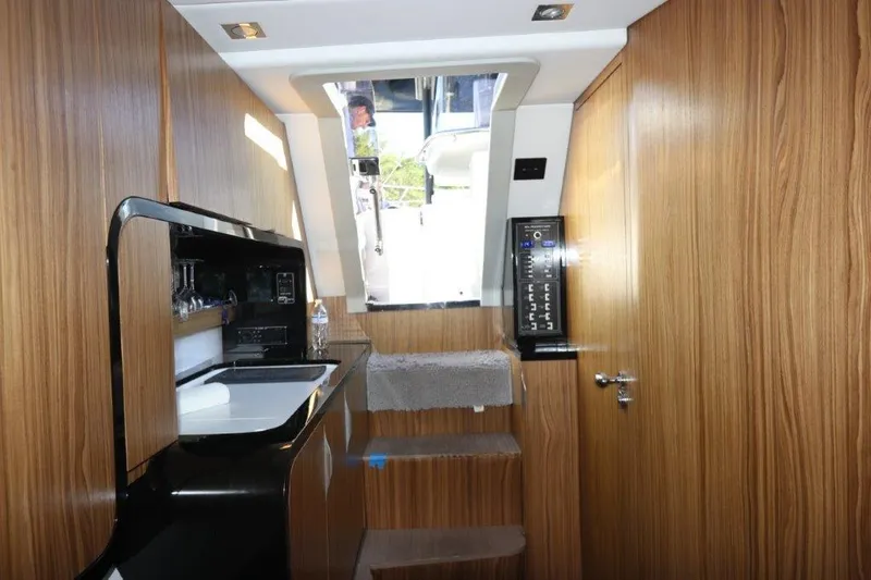 Slide: The Image of Interior of 2018 Canados Gladiator 428 yacht with wooden cabinetry and modern amenities. - 7