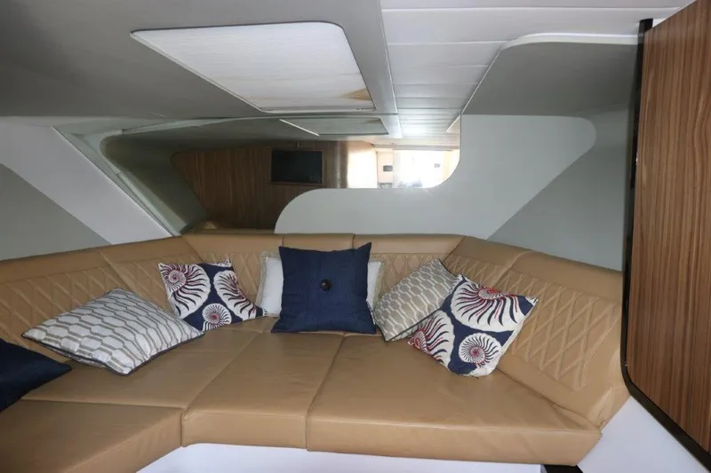 Slide: The Image of Interior of 2018 Canados Gladiator 428 yacht with tan seating and decorative pillows. - 8