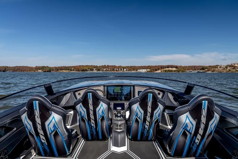 Slide: The Image of 2025 MTI 440X speedboat interior with four racing seats on a lake. - 10