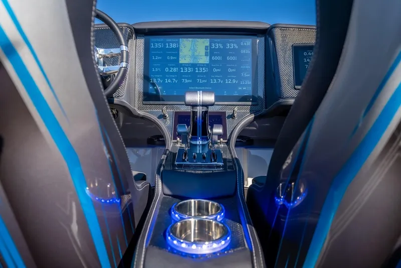 Slide: The Image of Interior of 2025 MTI 440X boat with advanced navigation system and illuminated cup holders. - 12