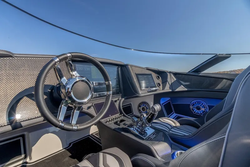 Slide: The Image of Interior of 2025 MTI 440X boat with modern dashboard and steering wheel. - 14