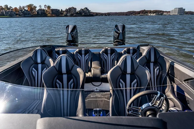 Slide: The Image of 2025 MTI 440X speedboat with luxury seating on a lake. - 16