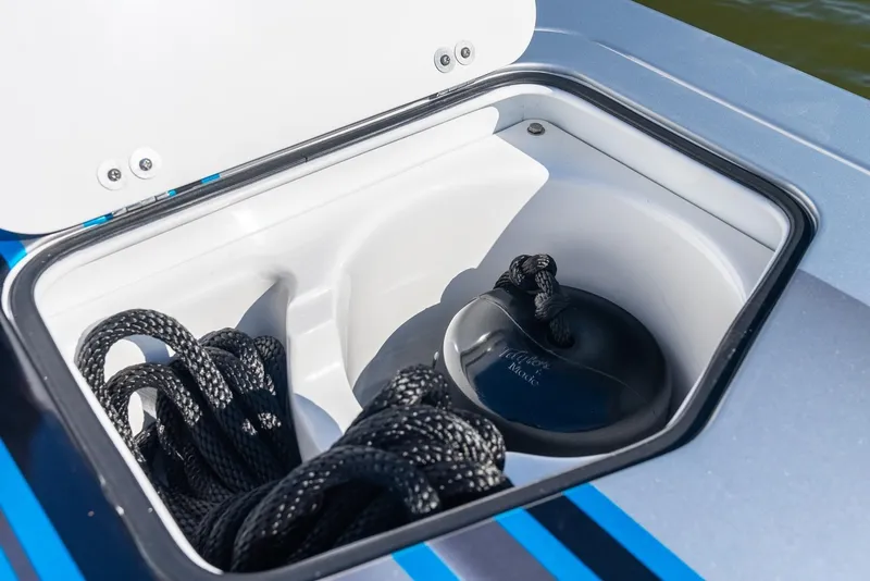 Slide: The Image of 2025 MTI 440X boat storage compartment with black ropes. - 18