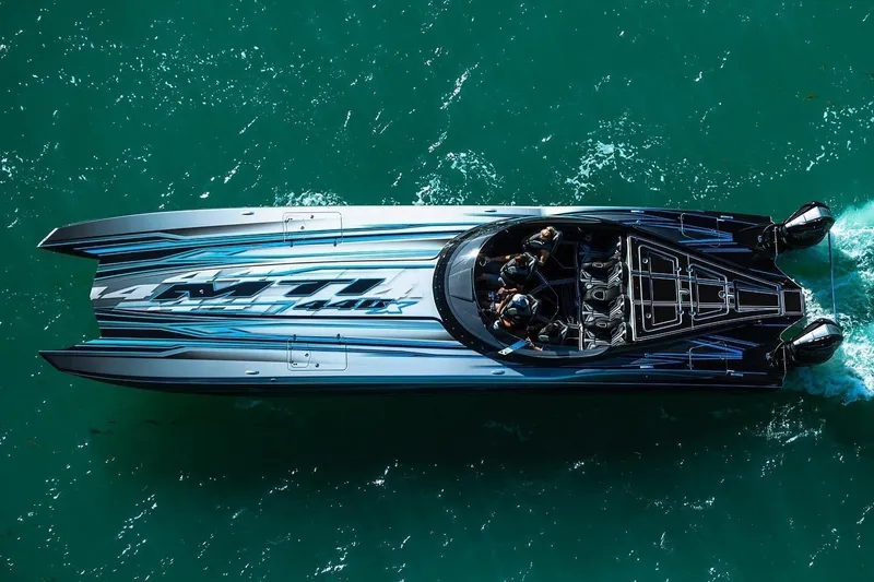 Slide: The Image of Aerial view of a 2025 MTI 440X speedboat on turquoise water. - 2