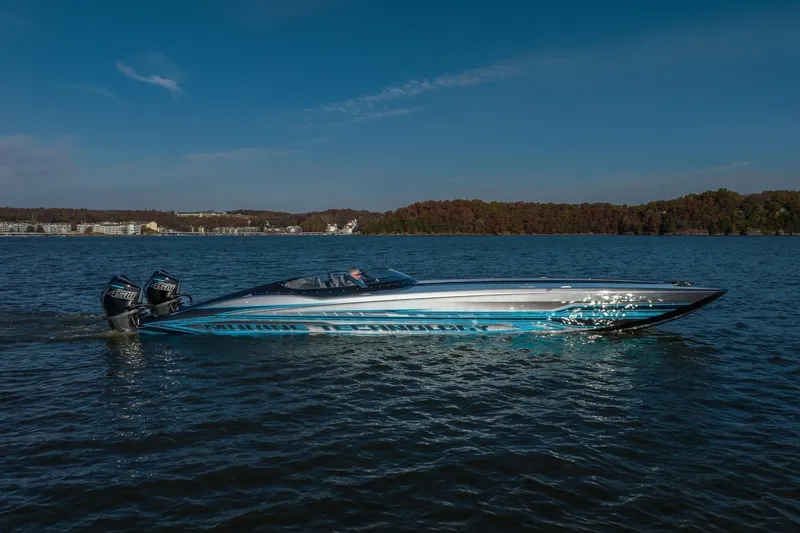 Slide: The Image of 2025 MTI 440X speedboat on a lake with scenic background. - 9