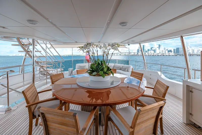 Slide: The Image of Luxurious Benetti Classic Supreme 132 yacht deck with elegant dining area, overlooking serene ocean view. - 31
