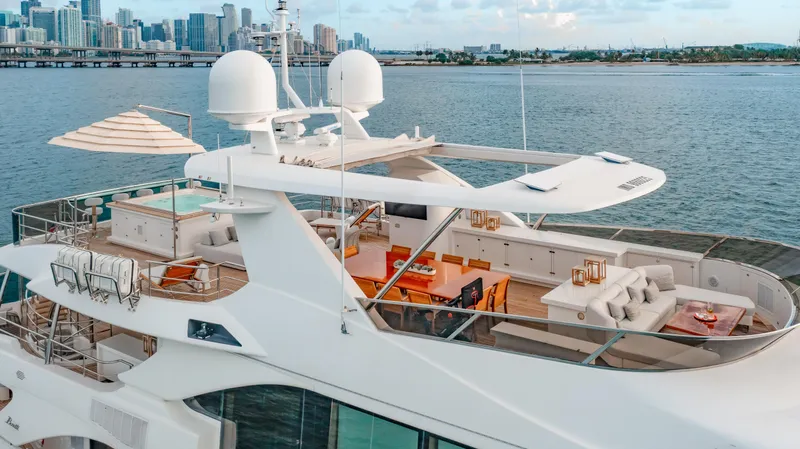 Slide: The Image of Luxurious 2012 Benetti Classic Supreme 132 yacht with spacious deck, city skyline in background. - 37