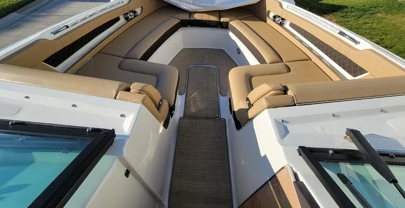 Slide: The Image of 2023 Sea Ray SLX 310 OB boat interior with tan seating and spacious layout. - 10