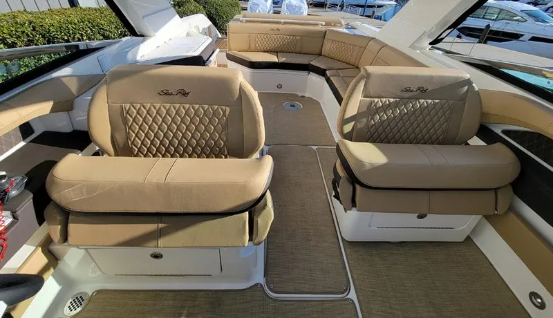 Slide: The Image of 2023 Sea Ray SLX 310 OB boat interior with luxurious tan seating and ample space. - 11